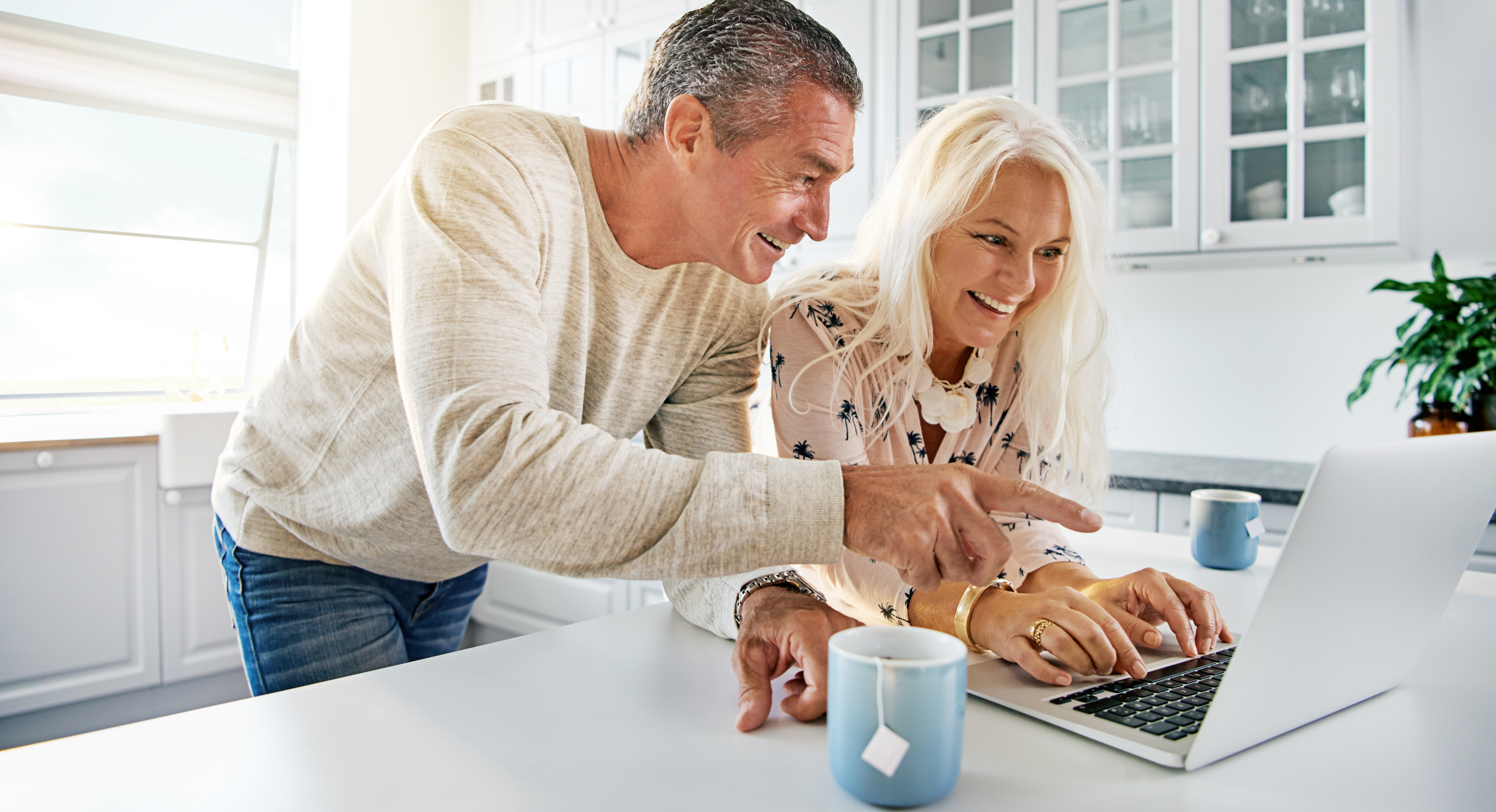 Caucassion_couple__happy_at_computer_AdobeStock_141181477