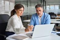 Woman_advisor_with_businessman_AdobeStock_1502530874